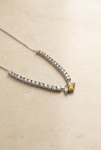 Load image into Gallery viewer, Diamond and yellow sapphire necklace on warm ivory stone