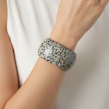 Load image into Gallery viewer, Grey Dalmatian jasper cuff bracelet on model wrist