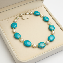 Load image into Gallery viewer, Turquoise baroque pearl necklace in cream velvet box uncrossed