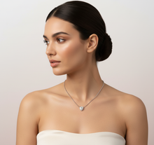 Load image into Gallery viewer, Woman wearing a diamond necklace with a heart pendant on a plain background
