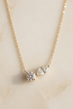 Load image into Gallery viewer, All-diamond two-stone necklace on warm ivory stone
