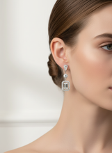 Load image into Gallery viewer, Emerald &amp; Pear Shape Diamond Dangle Earrings styled on model - original design
