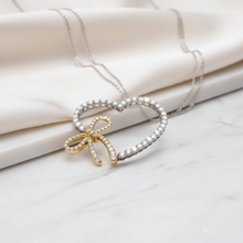 Load image into Gallery viewer, Enhanced heart pendant with gold love knot
