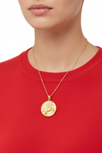 Load image into Gallery viewer, Model wearing gold horse pendant with diamond accents and red sweater
