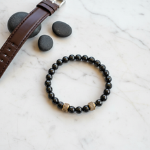 Load image into Gallery viewer, Men's Black Onyx Gold Barrel Bracelet Flat Lay
