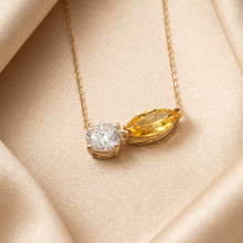 Load image into Gallery viewer, Yellow sapphire and diamond necklace on champagne satin
